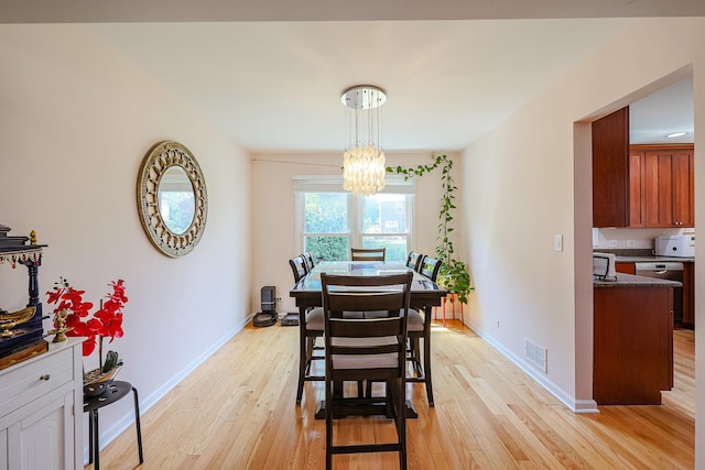 711 W Nichols Rd, Arlington Heights, IL 60004 - dining area featuring light wood-style floors and a chandelier