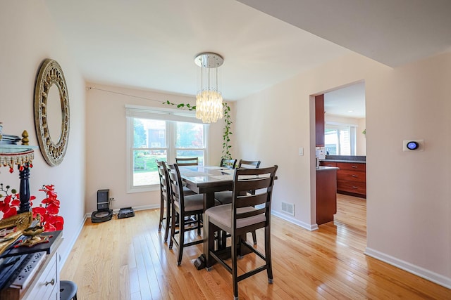 711 W Nichols Rd, Arlington Heights, IL 60004 - dining space featuring light wood-type flooring and a chandelier