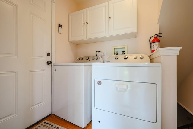 711 W Nichols Rd, Arlington Heights, IL 60004 - washroom featuring separate washer and dryer, cabinet space, and light wood-style flooring