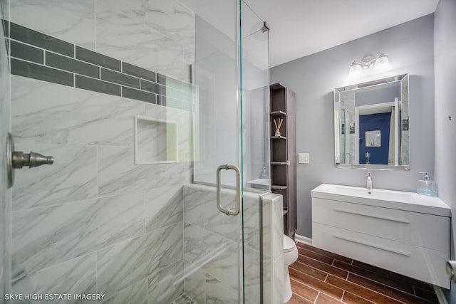 353 Eagle Ln, Bloomingdale, IL 60108 - bathroom featuring a stall shower, vanity, and wood tiled floors