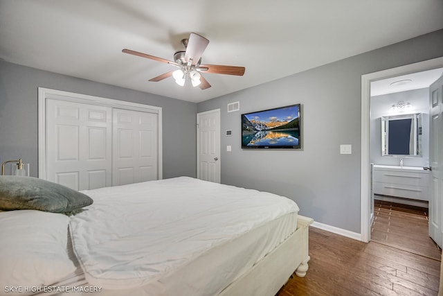 353 Eagle Ln, Bloomingdale, IL 60108 - bedroom with wood finished floors, a closet, connected bathroom, and a ceiling fan