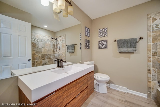 353 Eagle Ln, Bloomingdale, IL 60108 - bathroom with a tile shower, vanity, and wood finished floors