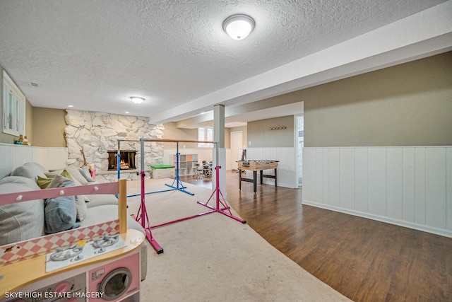 353 Eagle Ln, Bloomingdale, IL 60108 - finished below grade area with a textured ceiling, wood finished floors, and a wainscoted wall