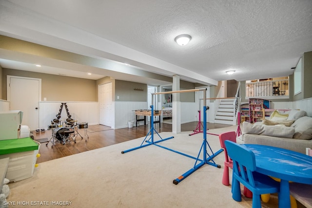 353 Eagle Ln, Bloomingdale, IL 60108 - recreation room featuring wood finished floors, wainscoting, and a textured ceiling