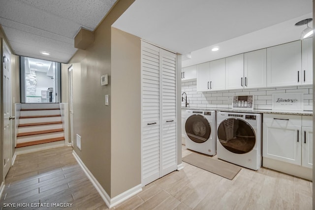 353 Eagle Ln, Bloomingdale, IL 60108 - laundry room with independent washer and dryer, light wood-style floors, recessed lighting, and cabinet space