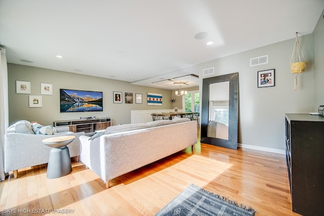 353 Eagle Ln, Bloomingdale, IL 60108 - living area with light wood finished floors, a chandelier, and recessed lighting