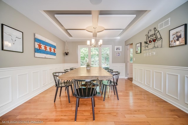 353 Eagle Ln, Bloomingdale, IL 60108 - dining area with coffered ceiling, a chandelier, a decorative wall, wainscoting, and light wood-style flooring