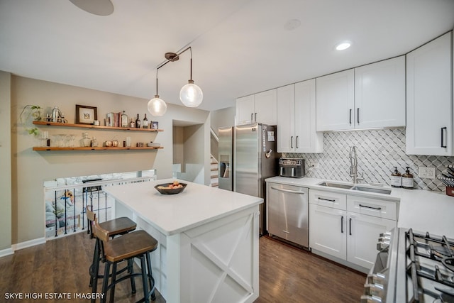 353 Eagle Ln, Bloomingdale, IL 60108 - kitchen with appliances with stainless steel finishes, light countertops, white cabinetry, backsplash, and a breakfast bar area