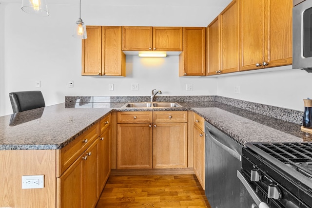 4537 S Drexel Blvd Unit 504, Chicago, IL 60653 - kitchen with stainless steel appliances, light wood finished floors, a peninsula, hanging light fixtures, and brown cabinets