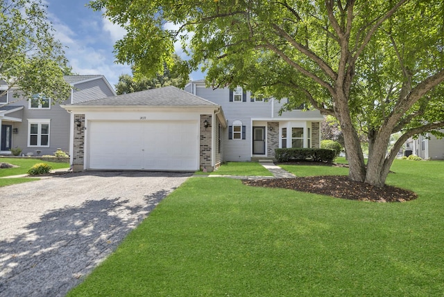 1439 Blue Heron Dr, Crystal Lake, IL 60014 - view of front of home featuring an attached garage, driveway, and a front yard