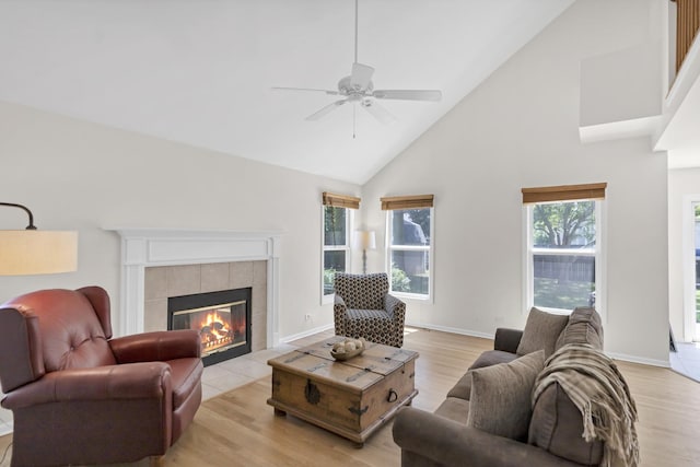 1439 Blue Heron Dr, Crystal Lake, IL 60014 - living area with high vaulted ceiling, a tile fireplace, a ceiling fan, and light wood finished floors