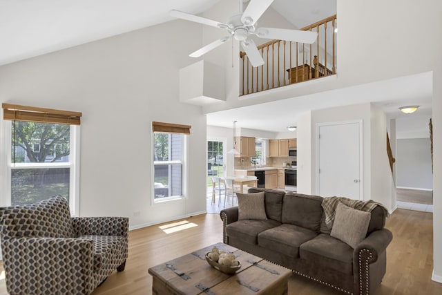1439 Blue Heron Dr, Crystal Lake, IL 60014 - living area featuring high vaulted ceiling, healthy amount of natural light, light wood-style flooring, and a ceiling fan