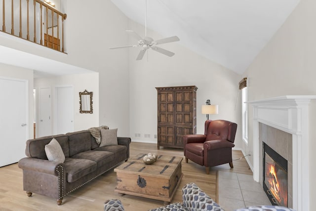 1439 Blue Heron Dr, Crystal Lake, IL 60014 - living area featuring high vaulted ceiling, a tiled fireplace, ceiling fan, and light tile patterned floors