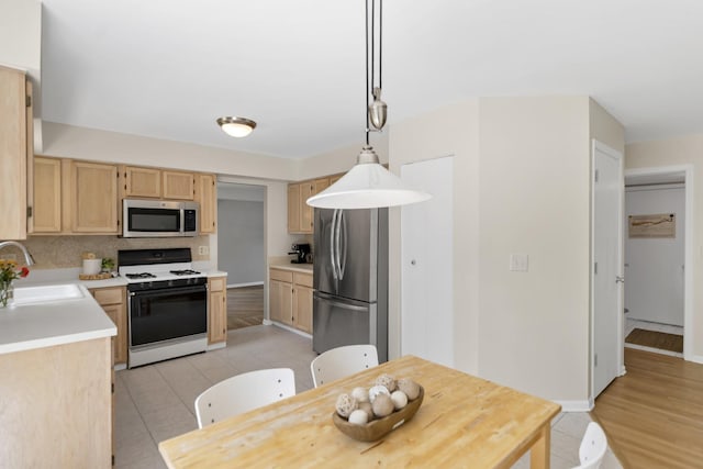 1439 Blue Heron Dr, Crystal Lake, IL 60014 - kitchen with stainless steel appliances, light brown cabinetry, light countertops, and light tile patterned flooring