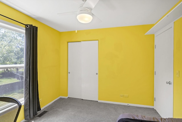 1439 Blue Heron Dr, Crystal Lake, IL 60014 - unfurnished bedroom featuring carpet flooring, a closet, and ceiling fan