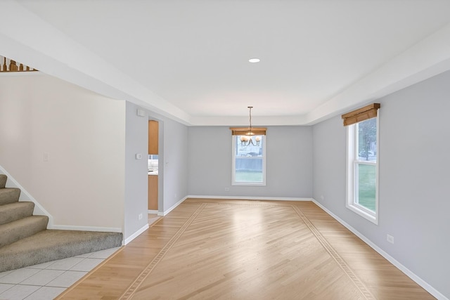 1439 Blue Heron Dr, Crystal Lake, IL 60014 - spare room featuring plenty of natural light, a chandelier, stairway, light wood finished floors, and recessed lighting