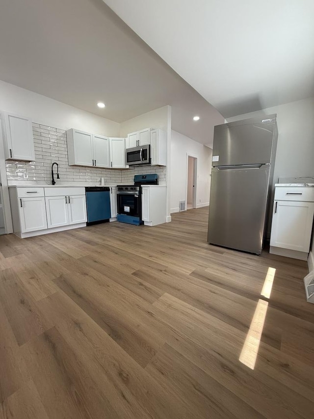11804 S State St, Chicago, IL 60628 - kitchen featuring appliances with stainless steel finishes, light wood-style flooring, backsplash, and recessed lighting