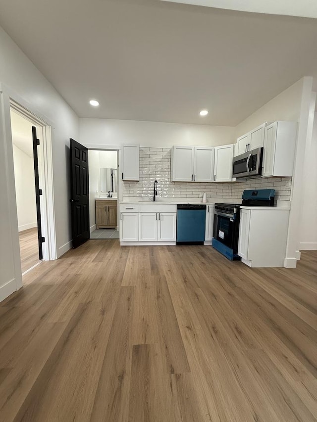 11804 S State St, Chicago, IL 60628 - kitchen with stainless steel microwave, dishwashing machine, range with electric stovetop, tasteful backsplash, and white cabinets
