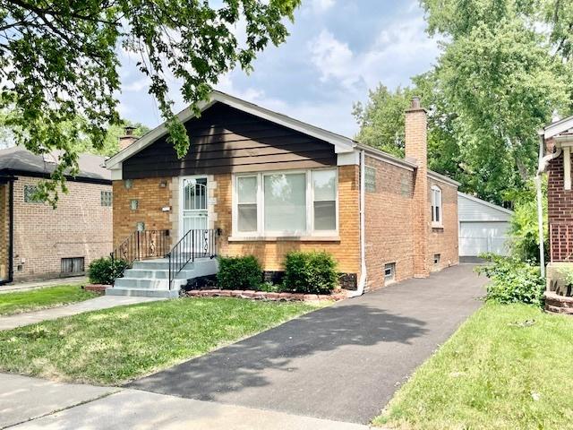 132 W 126th Pl, Chicago, IL 60628 - bungalow-style house with a chimney, brick siding, a front lawn, and a detached garage