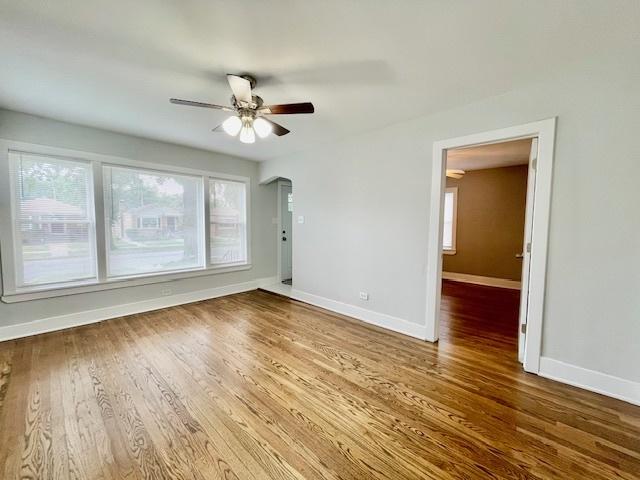132 W 126th Pl, Chicago, IL 60628 - unfurnished room featuring a ceiling fan, healthy amount of natural light, and wood finished floors