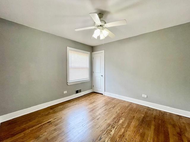 132 W 126th Pl, Chicago, IL 60628 - spare room featuring wood finished floors and a ceiling fan
