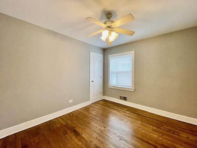 132 W 126th Pl, Chicago, IL 60628 - empty room featuring dark wood-style floors and ceiling fan
