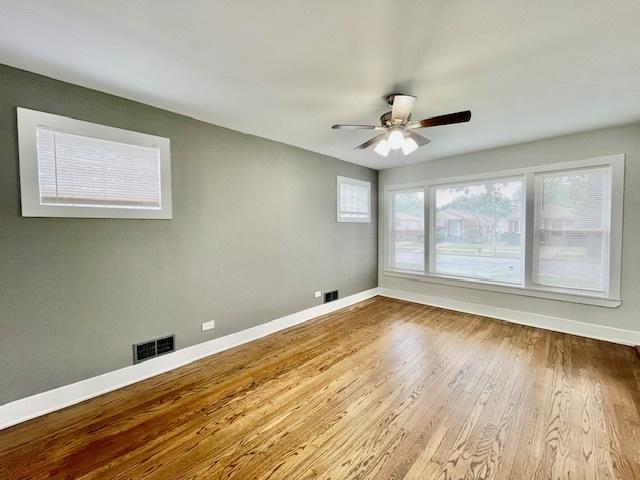 132 W 126th Pl, Chicago, IL 60628 - spare room with wood finished floors and ceiling fan