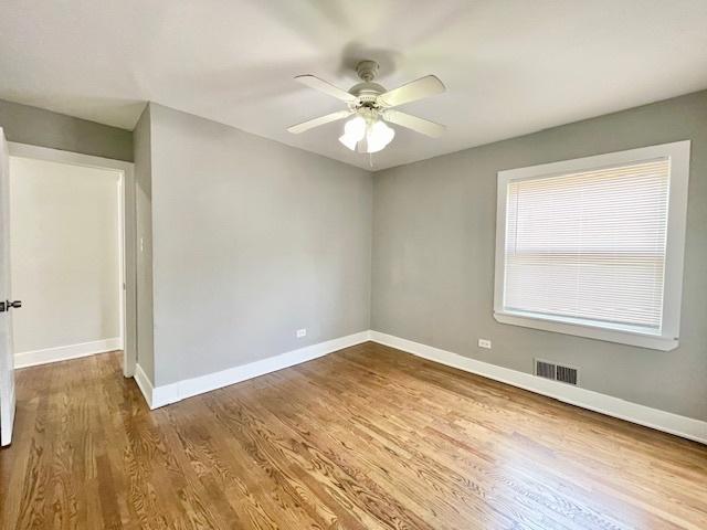 132 W 126th Pl, Chicago, IL 60628 - unfurnished room featuring ceiling fan and wood finished floors