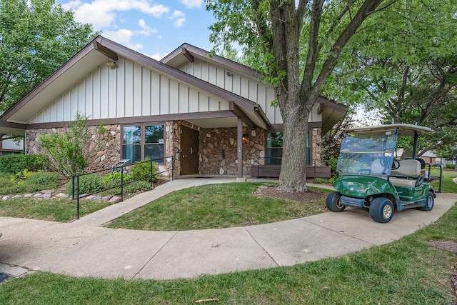 321 Woodbury Ct Unit D2, Schaumburg, IL 60193 - view of front of home with stone siding, board and batten siding, and a front lawn
