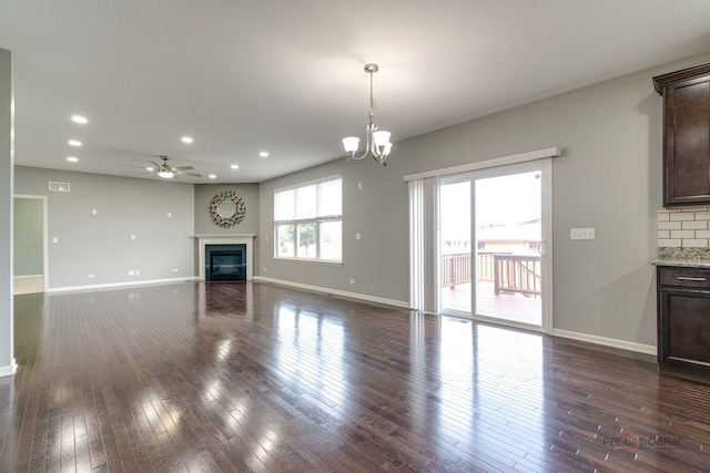 621 Blazing Star Dr, Lake Villa, IL 60046 - unfurnished living room featuring a glass covered fireplace, recessed lighting, dark wood-type flooring, a ceiling fan, and a chandelier