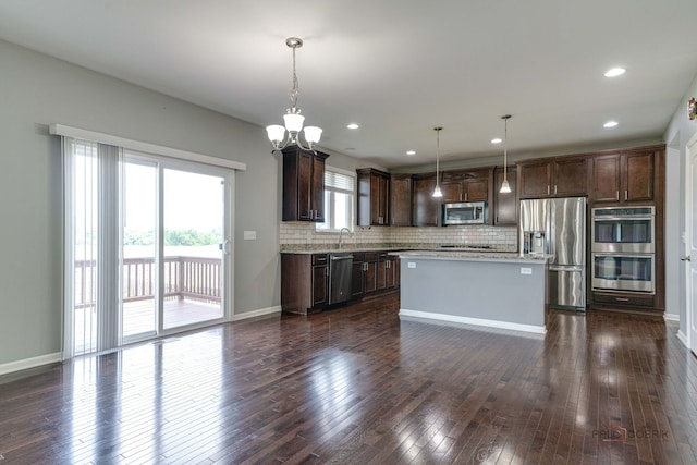 621 Blazing Star Dr, Lake Villa, IL 60046 - kitchen featuring appliances with stainless steel finishes, dark brown cabinets, backsplash, dark wood-type flooring, and recessed lighting