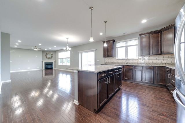 621 Blazing Star Dr, Lake Villa, IL 60046 - kitchen with dark brown cabinetry, a kitchen island, freestanding refrigerator, decorative backsplash, and recessed lighting