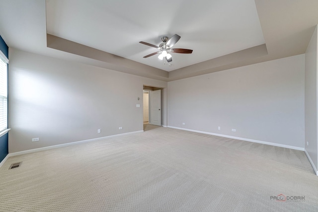 621 Blazing Star Dr, Lake Villa, IL 60046 - spare room featuring ceiling fan, light carpet, and a tray ceiling