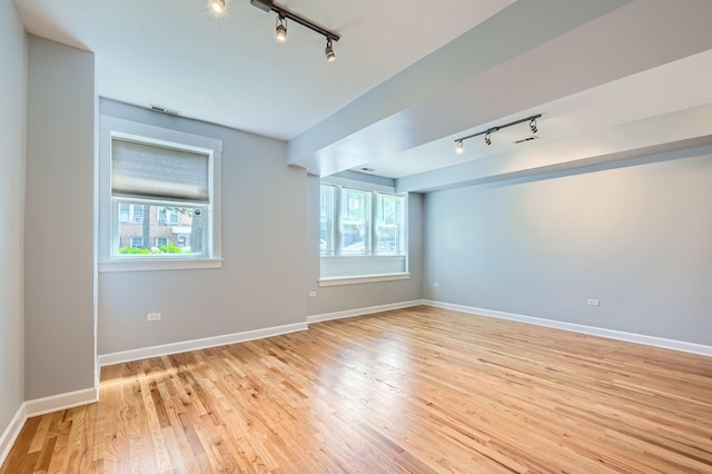 4056 N Albany Ave Unit G, Chicago, IL 60618 - spare room with rail lighting and light wood-style floors