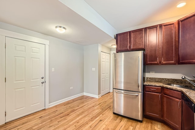 4056 N Albany Ave Unit G, Chicago, IL 60618 - kitchen featuring freestanding refrigerator, dishwasher, light wood-style flooring, and dark stone counters