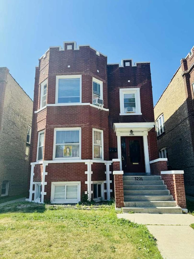 5221 W Montrose Ave, Chicago, IL 60641 - view of front of house featuring brick siding, a front yard, and cooling unit