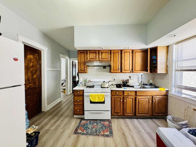 5221 W Montrose Ave, Chicago, IL 60641 - kitchen with white appliances, light wood finished floors, healthy amount of natural light, and under cabinet range hood