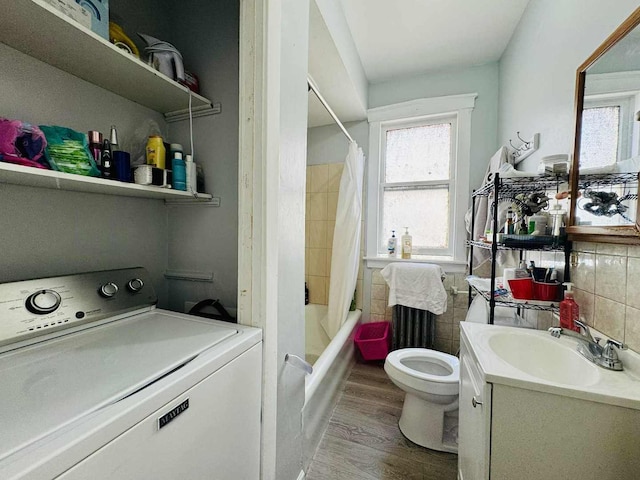 5221 W Montrose Ave, Chicago, IL 60641 - bathroom with washer / clothes dryer, vanity, plenty of natural light, and wood finished floors