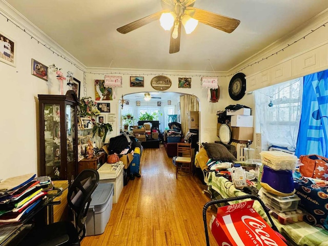 5221 W Montrose Ave, Chicago, IL 60641 - living area with a ceiling fan, light wood-style floors, arched walkways, and ornamental molding