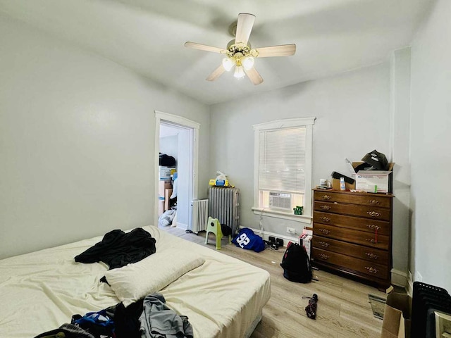 5221 W Montrose Ave, Chicago, IL 60641 - bedroom featuring radiator heating unit, wood finished floors, ceiling fan, and cooling unit