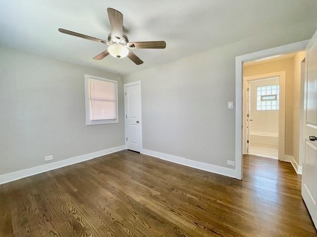 10049 S Calhoun Ave, Chicago, IL 60617 - empty room with ceiling fan and dark wood-type flooring