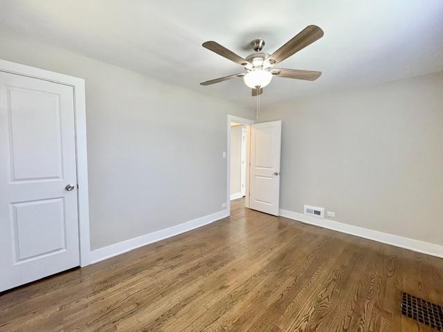 10049 S Calhoun Ave, Chicago, IL 60617 - empty room featuring a ceiling fan and wood finished floors