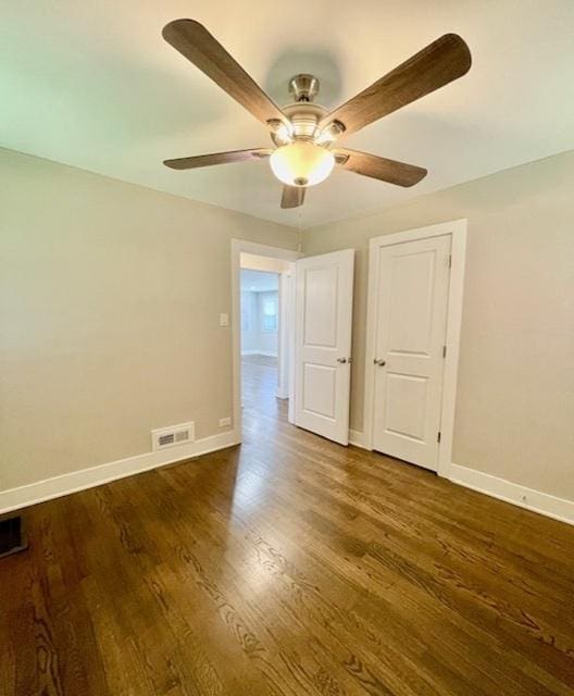10049 S Calhoun Ave, Chicago, IL 60617 - empty room with ceiling fan and dark wood-style floors