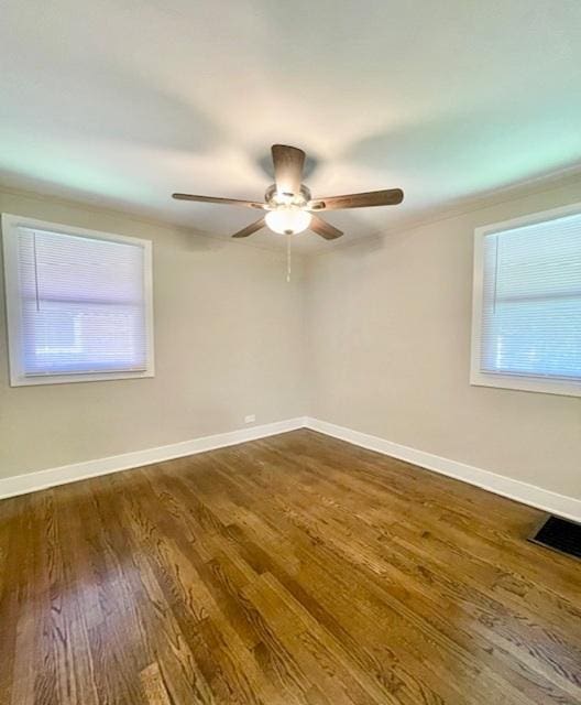 10049 S Calhoun Ave, Chicago, IL 60617 - spare room featuring dark wood-style flooring and ceiling fan