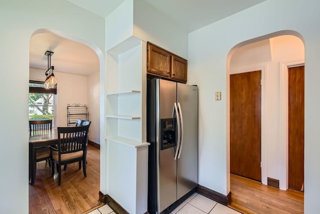 4017 Park Ave, Brookfield, IL 60513 - kitchen with stainless steel refrigerator with ice dispenser, arched walkways, light wood-style floors, and pendant lighting