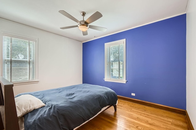 4017 Park Ave, Brookfield, IL 60513 - bedroom with wood finished floors, crown molding, multiple windows, and a ceiling fan