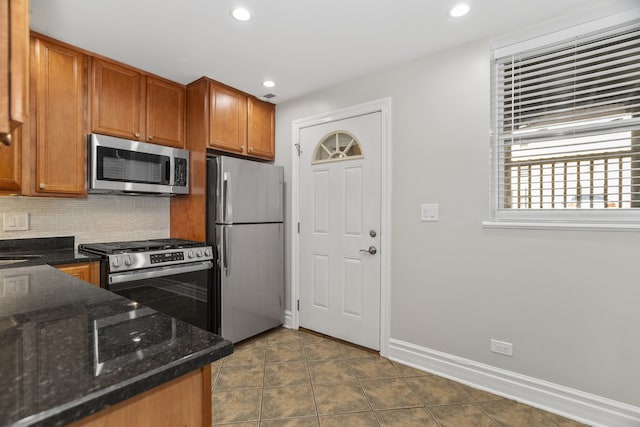5656 N Kimball Ave Unit Gs, Chicago, IL 60659 - kitchen with stainless steel appliances, decorative backsplash, brown cabinetry, recessed lighting, and dark stone counters