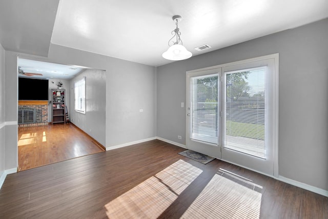 706 Shining Water Dr, Carol Stream, IL 60188 - unfurnished dining area featuring wood finished floors, a fireplace, and ceiling fan