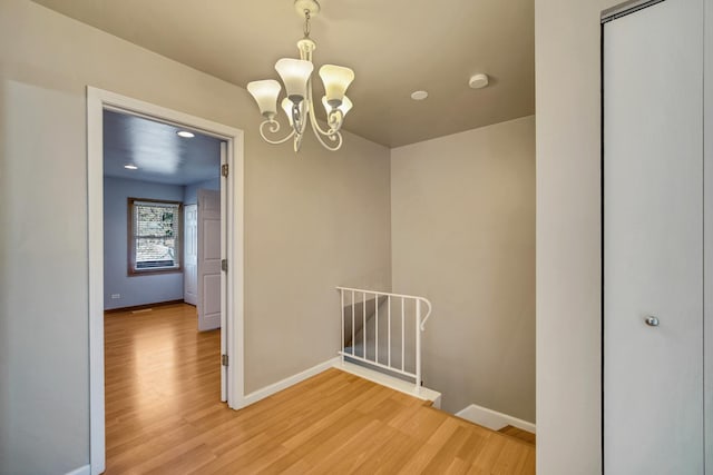 706 Shining Water Dr, Carol Stream, IL 60188 - unfurnished room featuring light wood finished floors, a smoke detector, and a chandelier