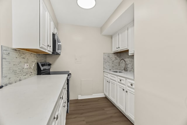 6432 N Ridge Ave Unit 3I, Chicago, IL 60626 - kitchen featuring stainless steel appliances, decorative backsplash, white cabinets, and dark wood finished floors